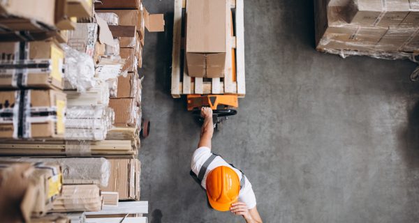 Young man working at a warehouse with boxes Young man working at a warehouse with boxes